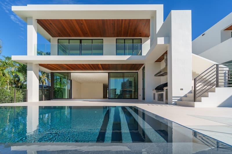 Modern luxury home exterior with pool at twilight